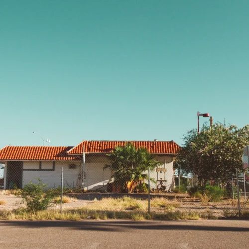 house-with-fence-around-it-with-clear-sky